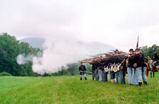 Smoke rolls from a line of rifle fire